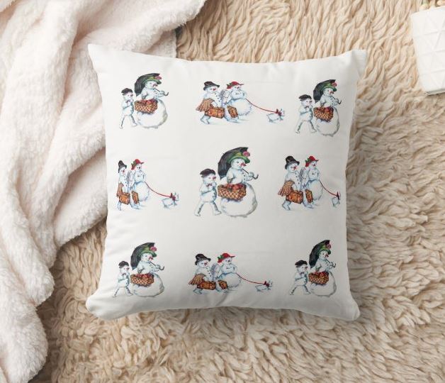 Gorgeous Christmas throw pillow featuring snowmen. A snowman couple with an adorable snow dog and a snowman mother and child.